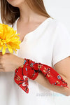 a woman in a white shirt and red tie 